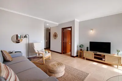 a living room with a couch and a flat screen tv at Sunrise Salgados Village in Galé