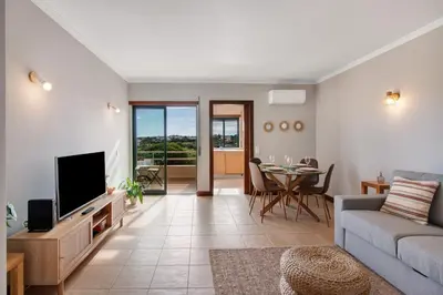 a living room with a couch and a tv at Sunrise Salgados Village in Galé