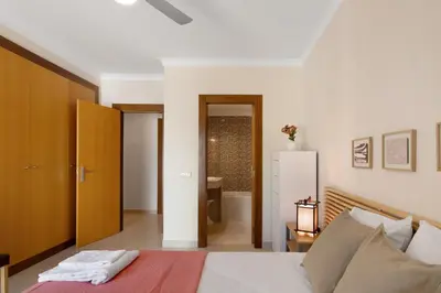 a bedroom with a bed and a bathroom at Apart Condomínio do Vale in Guia