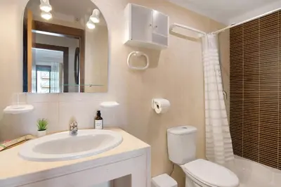 a hotel room with two beds and a window at Apart Condomínio do Vale in Guia