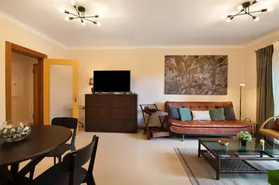 a living room with a couch and a table at Apart Condomínio do Vale in Guia