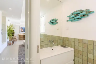 a corridor with white walls and a hallway with doors at Villa Alba - Albufeira Premium by Misha's Place in Albufeira