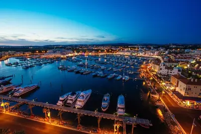 a harbor with boats in the water at night at Quarteira-Your Seaside Getaway in Quarteira