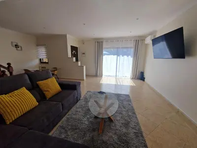 a living room with a couch and a glass table at Holiday home in Albufeira in Albufeira