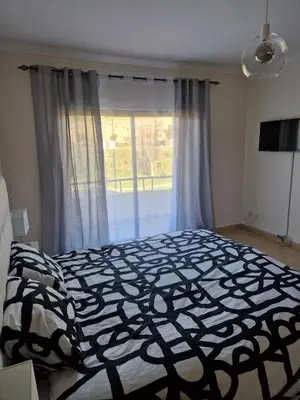 a bedroom with a black and white bed and a window at Holiday home in Albufeira in Albufeira
