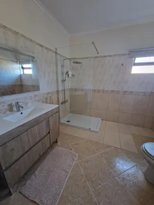 a bathroom with a sink and a shower and a toilet at Holiday home in Albufeira in Albufeira