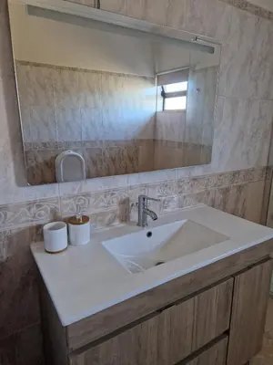 a bathroom with a sink and a mirror at Holiday home in Albufeira in Albufeira