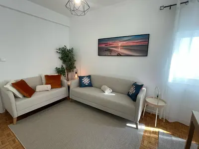 a living room with two couches and a table at Casa da Baixa in Faro