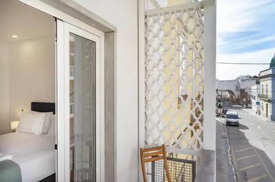 a bedroom with a bed and a window at Faro DAZ House by Get Your Stay in Faro