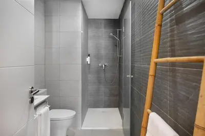 a bathroom with a shower and a toilet in it at Faro DAZ House by Get Your Stay in Faro