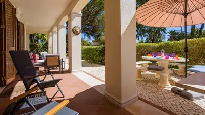 a patio with a table and an umbrella at 3Br Apt-Quinta do Lago-Private Terrace in Quinta do Lago