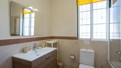 a bathroom with a sink and a toilet and a mirror at 3Br Apt-Quinta do Lago-Private Terrace in Quinta do Lago