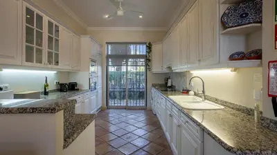 a kitchen with white cabinets and a sink at 3Br Apt-Quinta do Lago-Private Terrace in Quinta do Lago