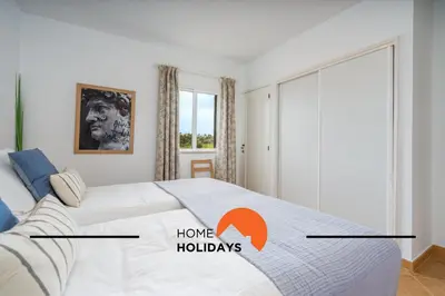 a bedroom with a bed with the wordshaveholidays at #294 T2 Com Amplo Terraço by Home Holidays in Albufeira
