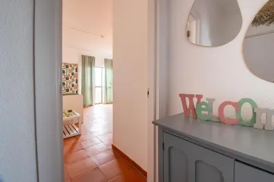 a room with a mirror on the wall and a table at BeGuest Vila Magna Apartment in Albufeira