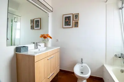 a bathroom with a sink and a toilet and a tub at BeGuest Vila Magna Apartment in Albufeira