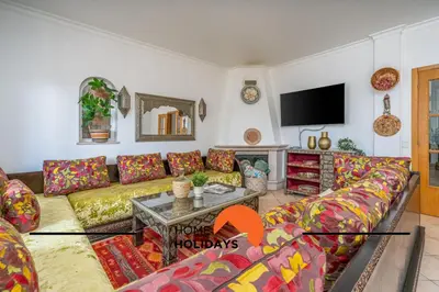 a living room with a couch and a table at #298 Villas Luz H by Home Holidays in Albufeira