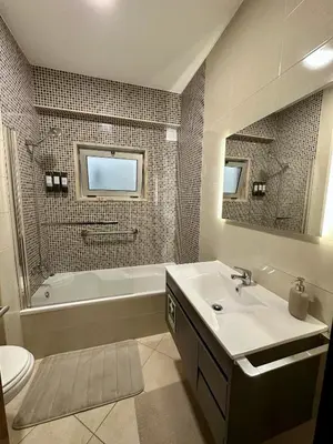 a bathroom with a sink and a tub and a toilet at Beach, please! in Quarteira