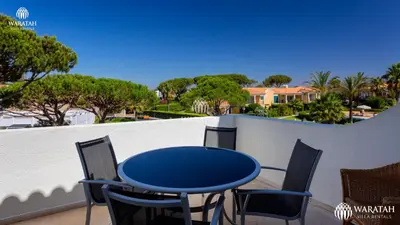 a blue table and chairs on a balcony at Apartment Lamine in Loulé