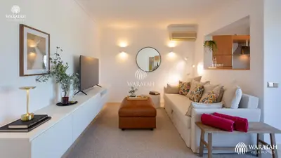 a living room with a couch and a mirror at Apartment Lamine in Loulé