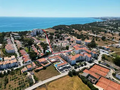 a house on the beach with the ocean in the background at Alfamar e Falésia in Albufeira