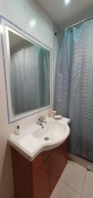 a bathroom with a sink and a large mirror at Alfamar e Falésia in Albufeira