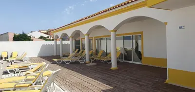 a group of chairs sitting on a deck at Alfamar e Falésia in Albufeira