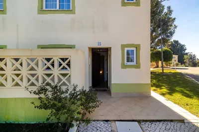two twin beds in a room with a window at Ponta Grande Resort - Villa Coral in Albufeira