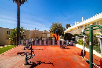 a white house with a tree in front of it at Ponta Grande Resort - Villa Coral in Albufeira