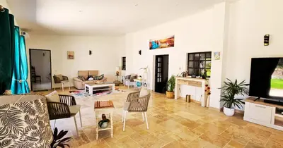 a living room with a couch and a tv at Quinta Azul in Loulé