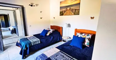 a bedroom with two beds with blue pillows at Quinta Azul in Loulé