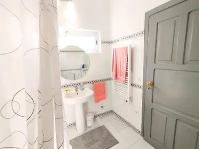 a white bathroom with a sink and a mirror at Quinta Azul in Loulé