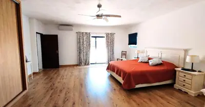 a bedroom with a bed and a ceiling fan at Quinta Azul in Loulé