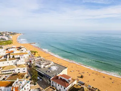 an aerial view of a beach with buildings and the ocean at Sun&Sea in Albufeira