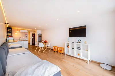 a living room with a couch and a tv on the wall at Sun&Sea in Albufeira