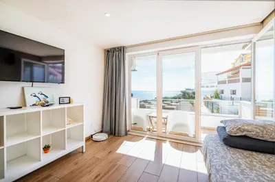 a bedroom with a bed and a view of the ocean at Sun&Sea in Albufeira