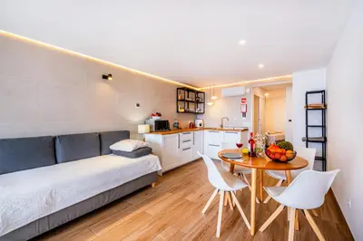a bedroom with a bed and a table and chairs at Sun&Sea in Albufeira