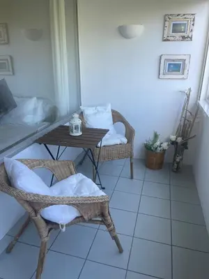 a table and chairs in a room with a table and a chair at Casa Ligia in Vilamoura