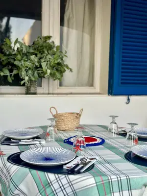 a table with plates and napkins on top of it at Balaia Gardens in Albufeira in Albufeira