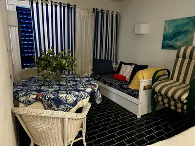 a small living room with a table and a couch at Balaia Gardens in Albufeira in Albufeira