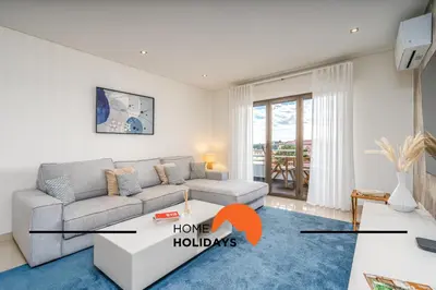 a living room with a couch and a table at #249 Sapphire Shoreline Lodge by Home Holidays in Albufeira