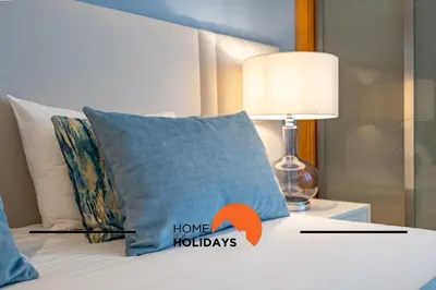 a pillow with the words home holidays written on it on a bed at #249 Sapphire Shoreline Lodge by Home Holidays in Albufeira