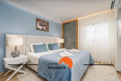 a bedroom with a bed with a home holidays sign on it at #249 Sapphire Shoreline Lodge by Home Holidays in Albufeira