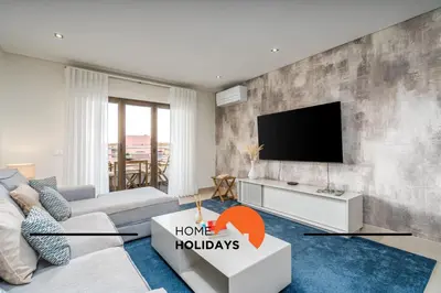 a living room with a couch and a tv at #249 Sapphire Shoreline Lodge by Home Holidays in Albufeira