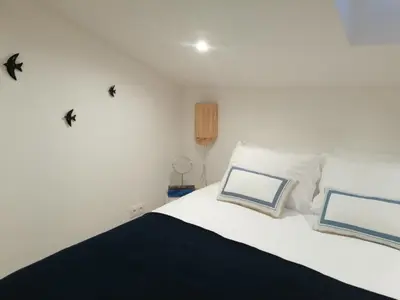 a bedroom with a bed with birds on the wall at Casa Corisca - stylish, cosy, top location in the heart of Faro in Faro