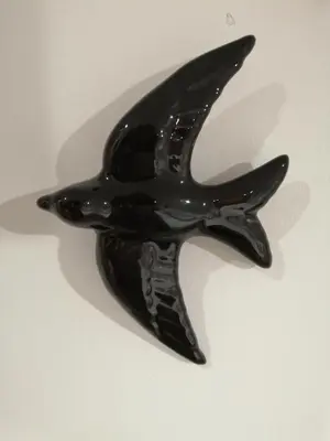 a black bird shaped object is sitting on a table at Casa Corisca - stylish, cosy, top location in the heart of Faro in Faro