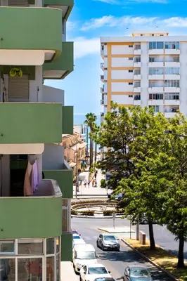 a view of a city street with buildings at Bright & Stylish 2bedflat 5min Walk to beach in Quarteira Vilamoura in Quarteira
