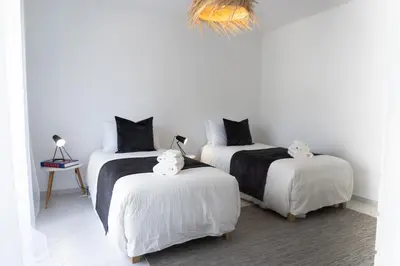 a room with three beds with cats on them at Bright & Stylish 2bedflat 5min Walk to beach in Quarteira Vilamoura in Quarteira