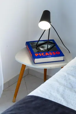 a lamp sitting on a table next to a bed at Bright & Stylish 2bedflat 5min Walk to beach in Quarteira Vilamoura in Quarteira