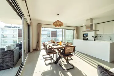 a kitchen and dining room with a table and chairs at The Green Escape Albufeira Poolside Retreat in Albufeira